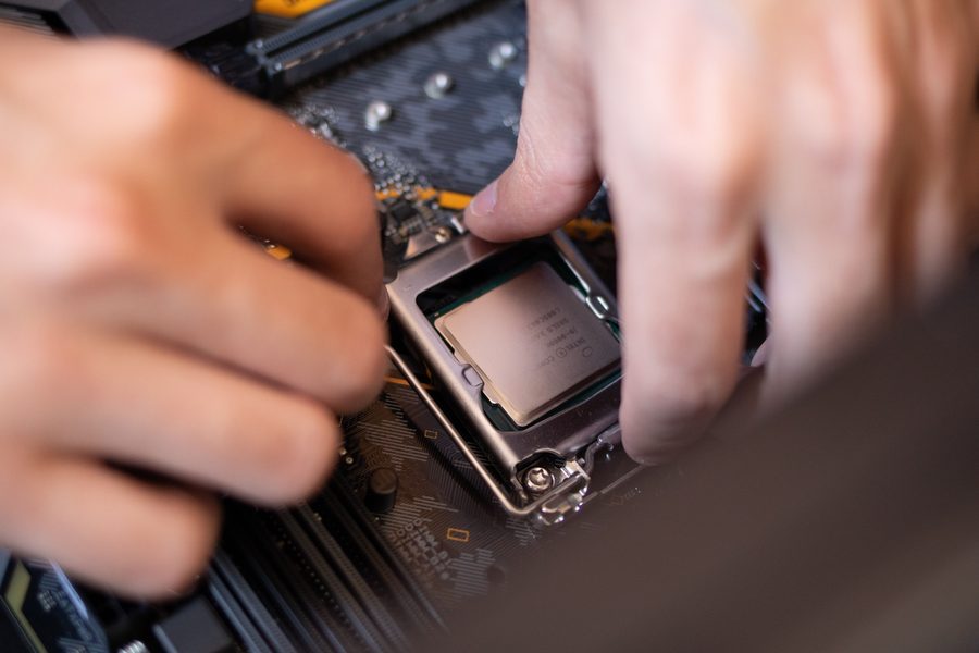 Close-up of hands installing a computer processor