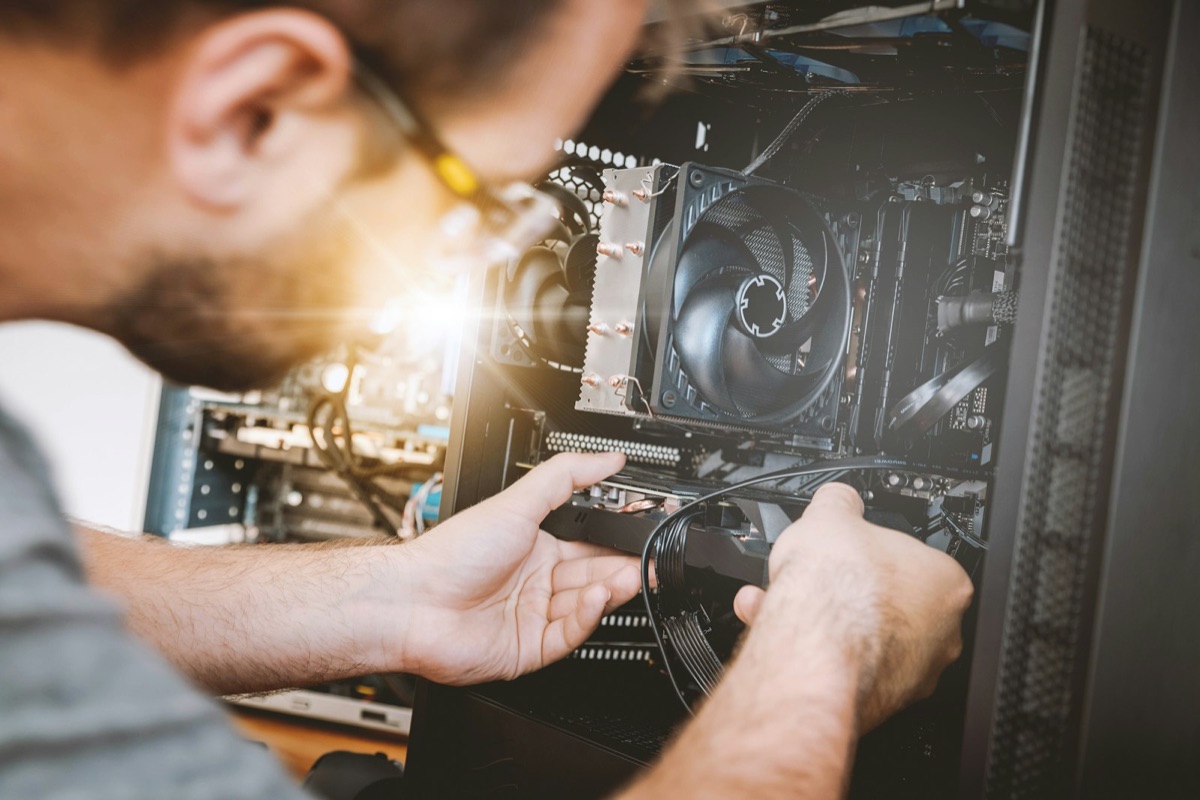 Technician installing and configuring hardware components