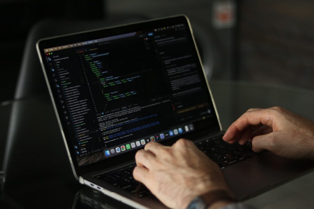 Developer typing code on a laptop