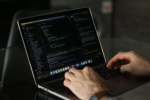 Developer typing code on a laptop